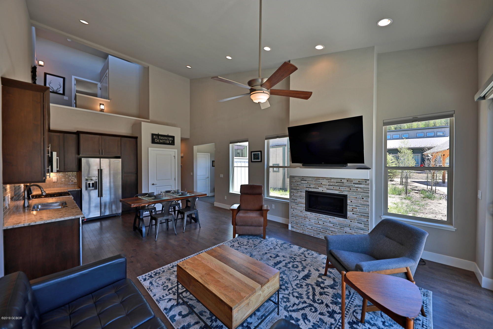 a living room with furniture fireplace and flat screen tv