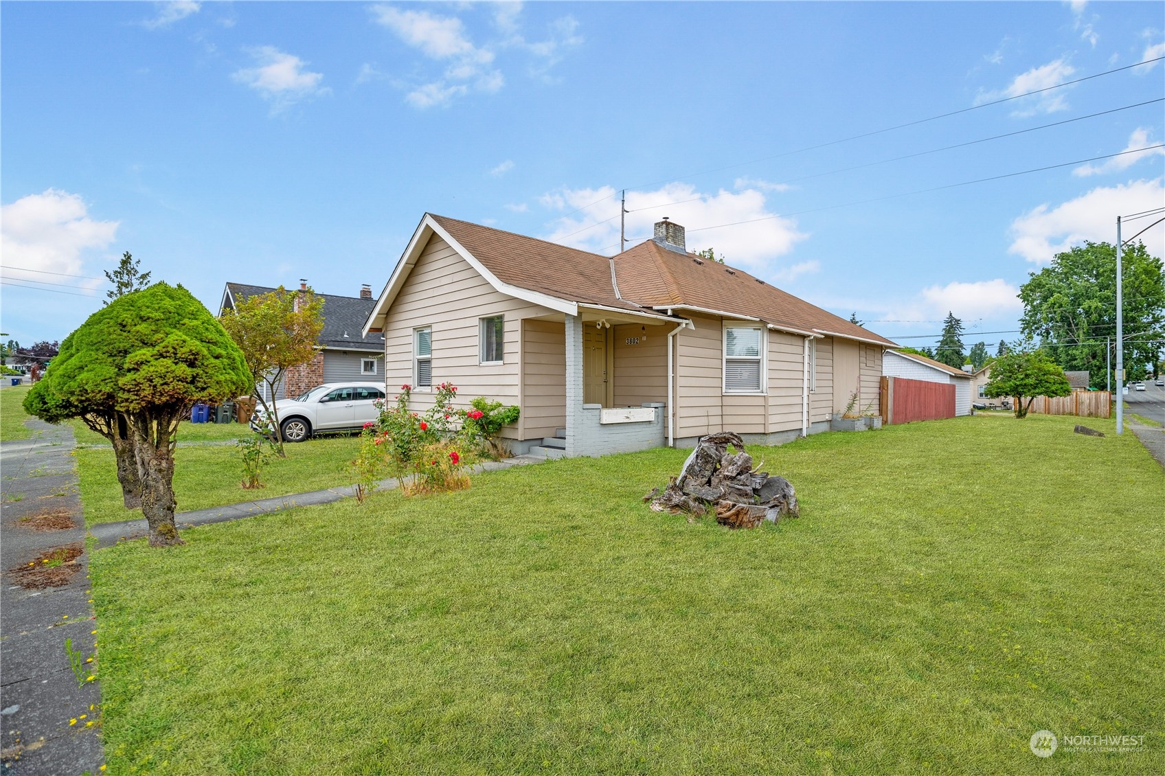 a front view of house with outdoor seating and green space