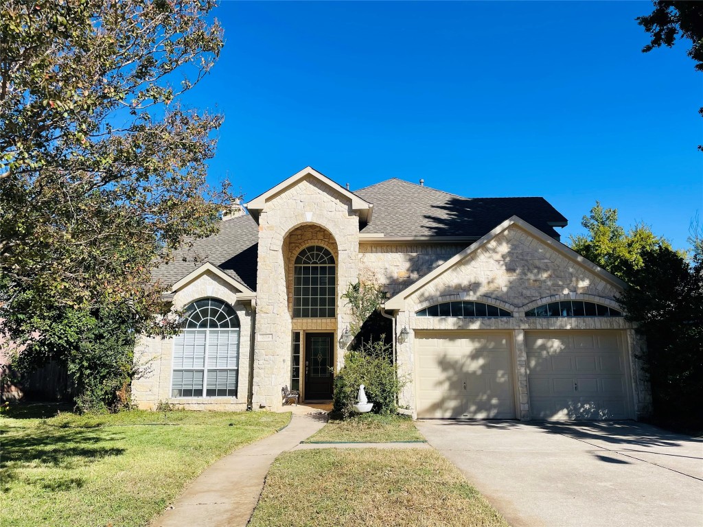 a front view of a house with a yard