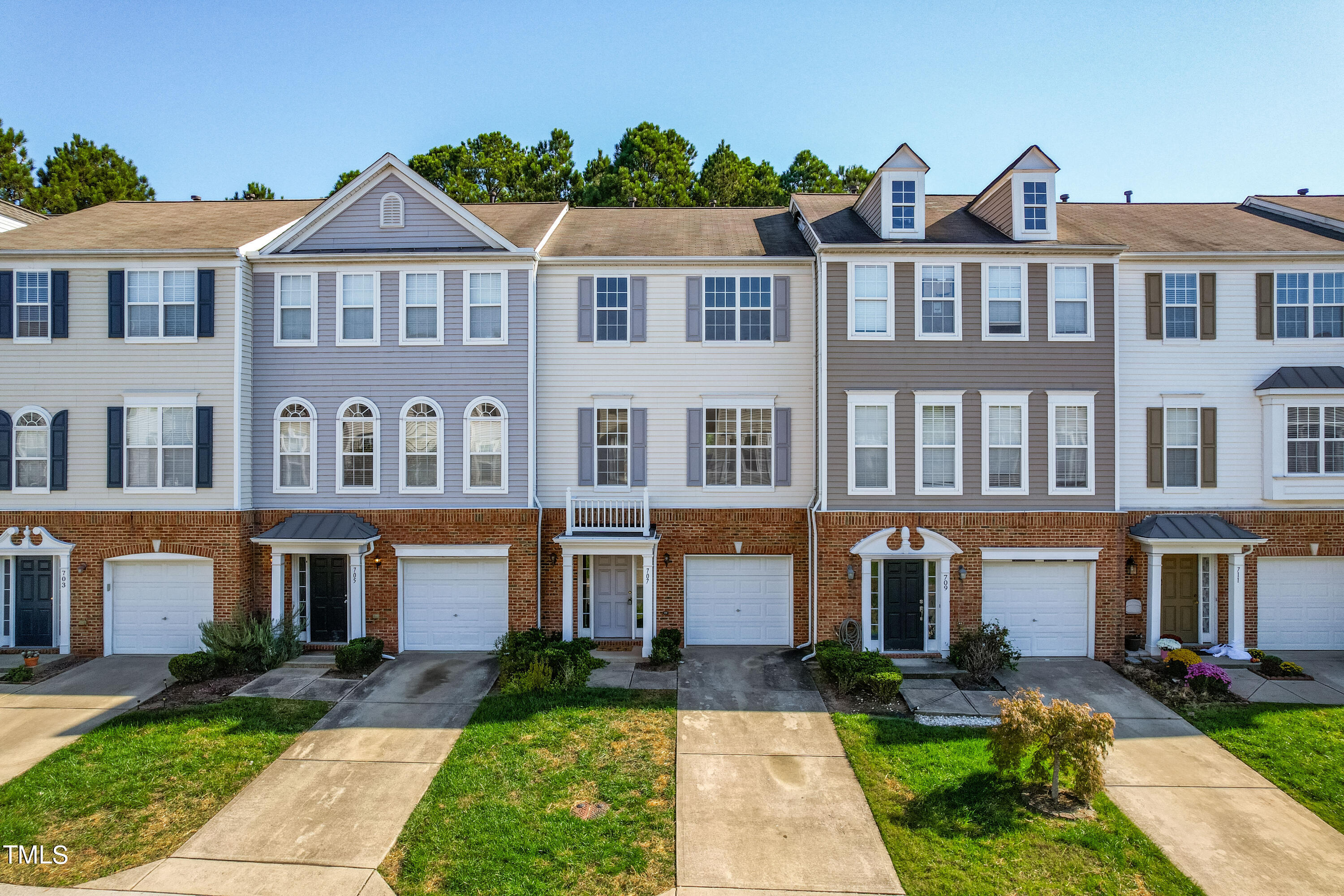 a front view of a residential apartment building with a yard