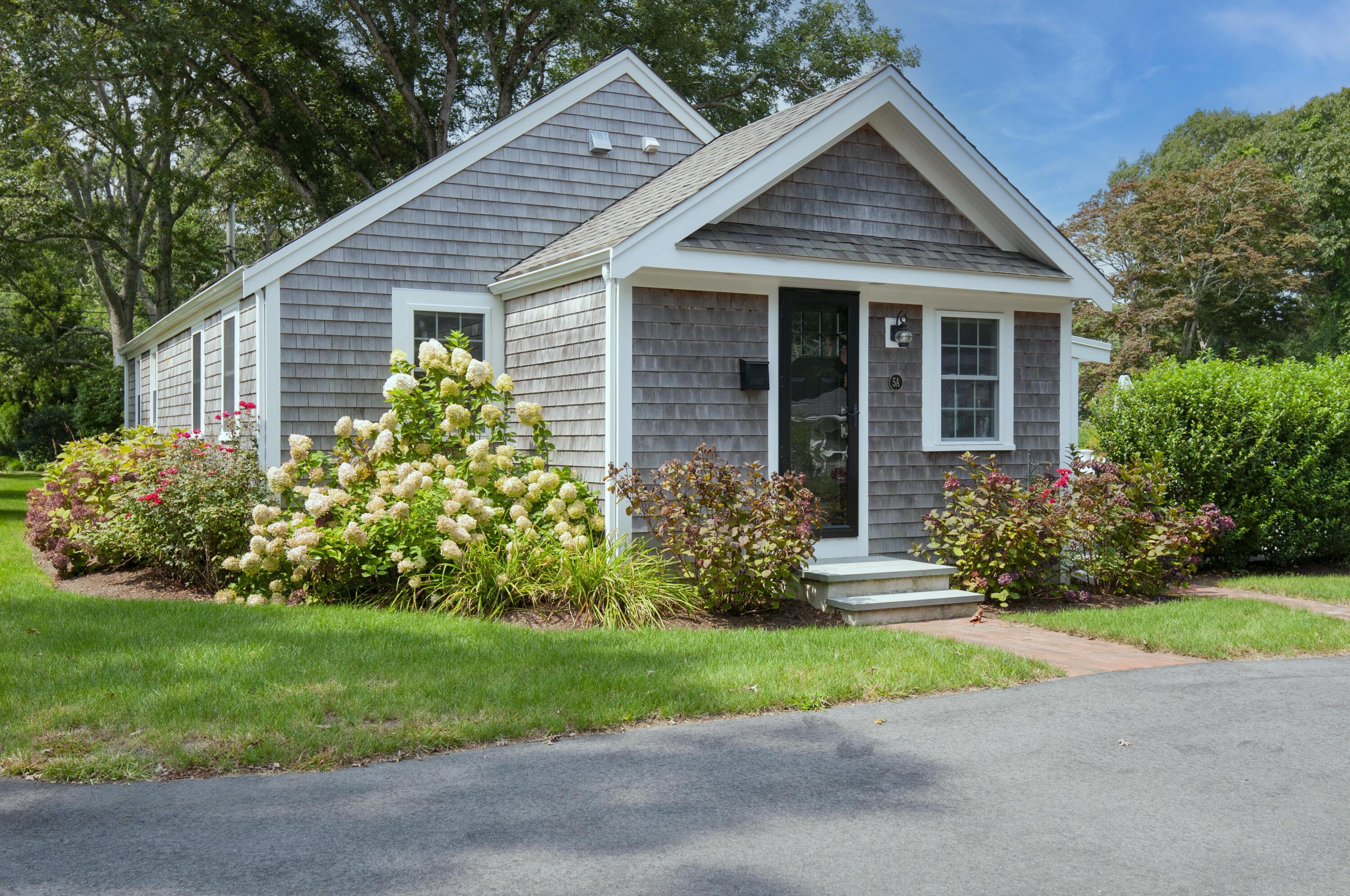 a front view of house with yard and green space