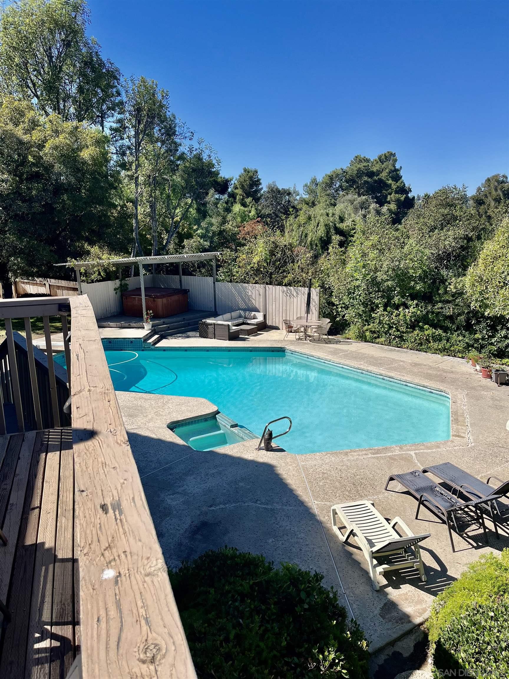 a view of a backyard with swimming pool