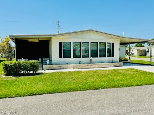 a view of a house with a yard patio and a garden