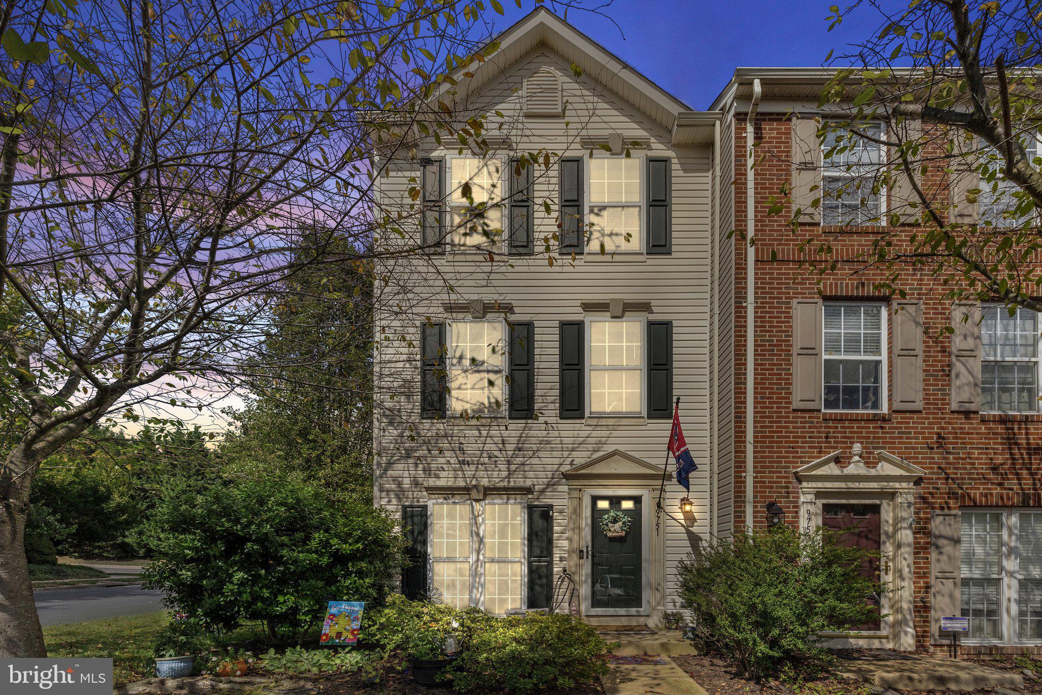 a front view of a residential apartment building with a yard