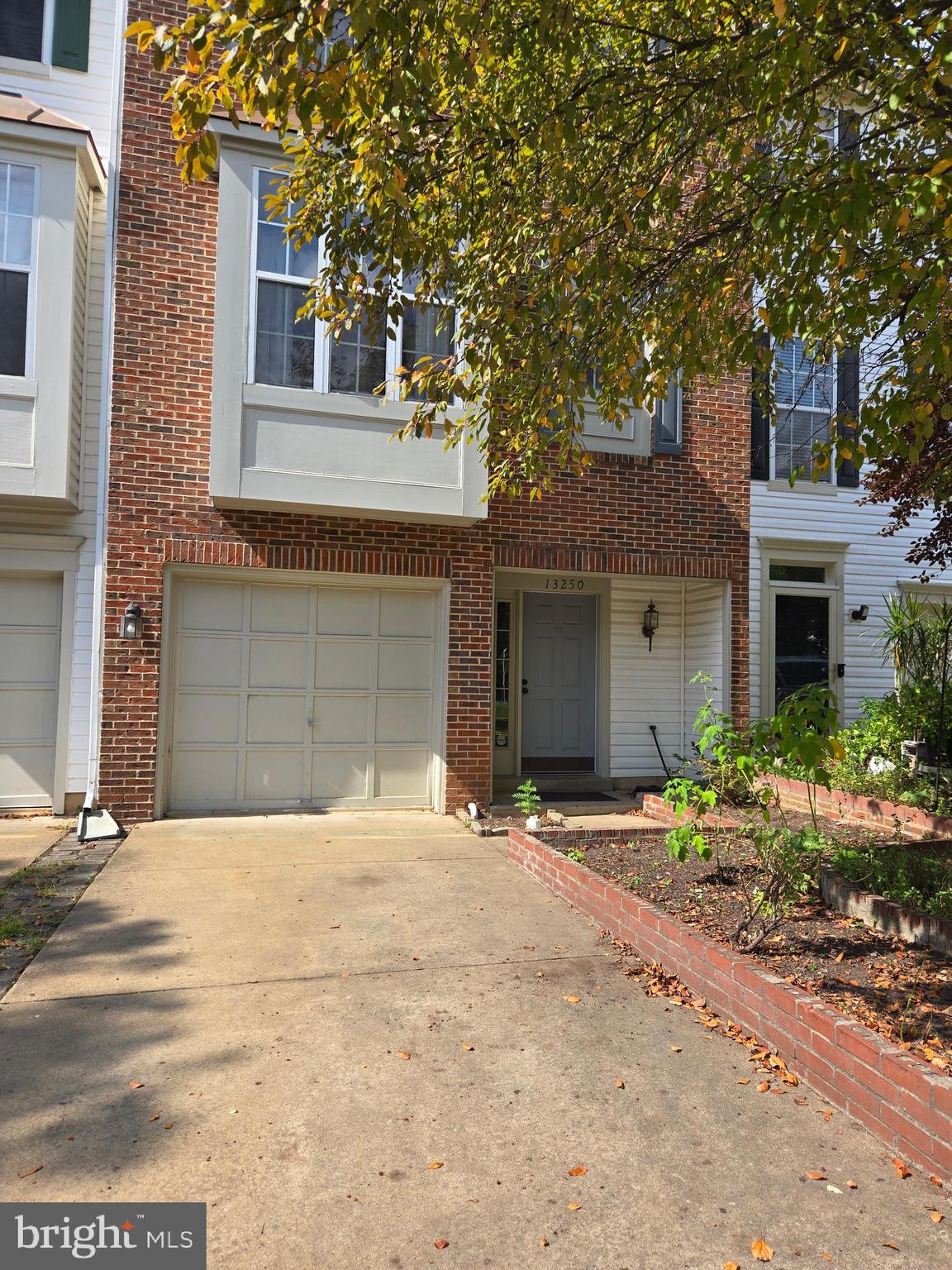 a front view of a house with a yard and a garage