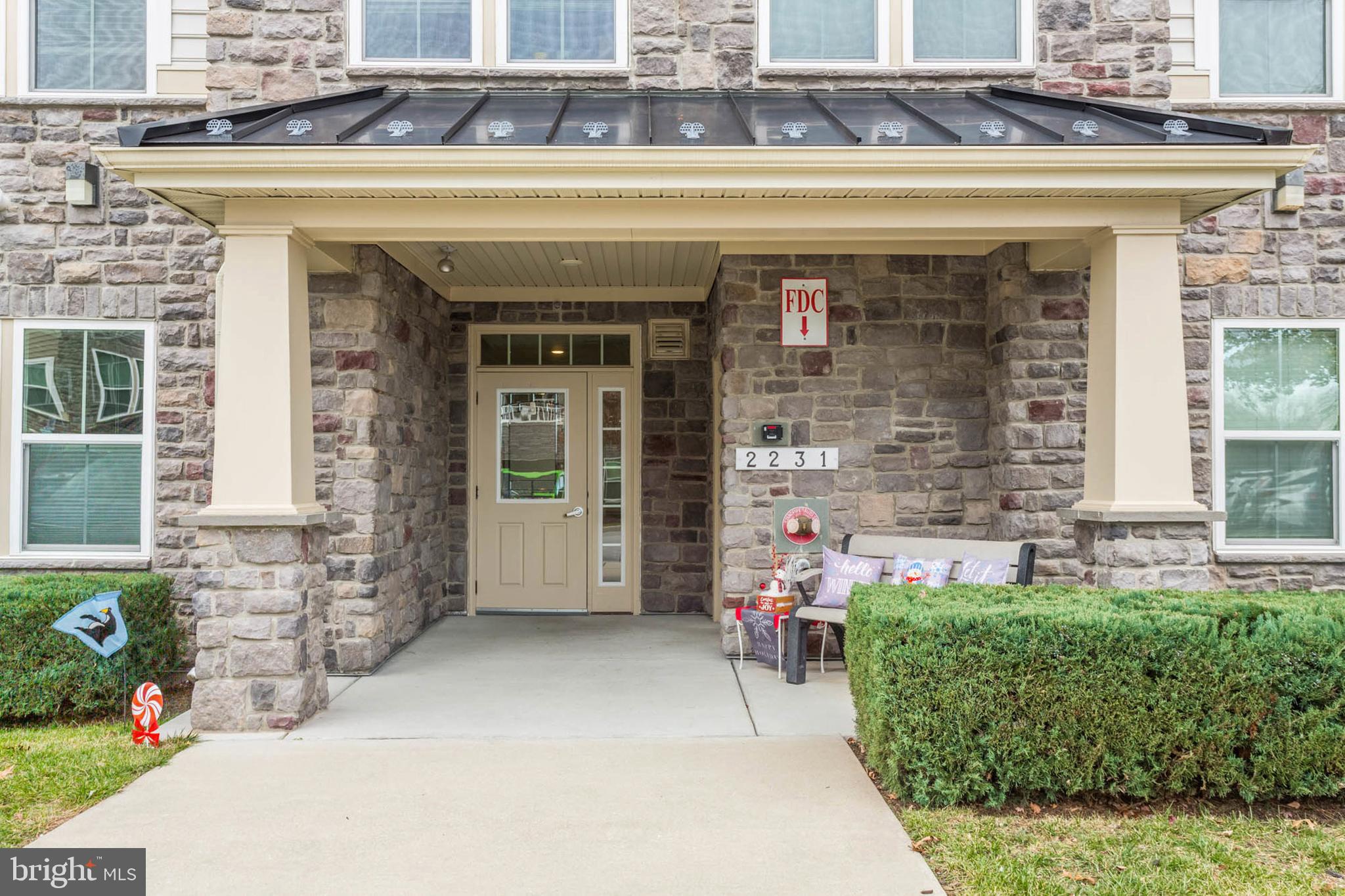 a front view of a building with outdoor seating