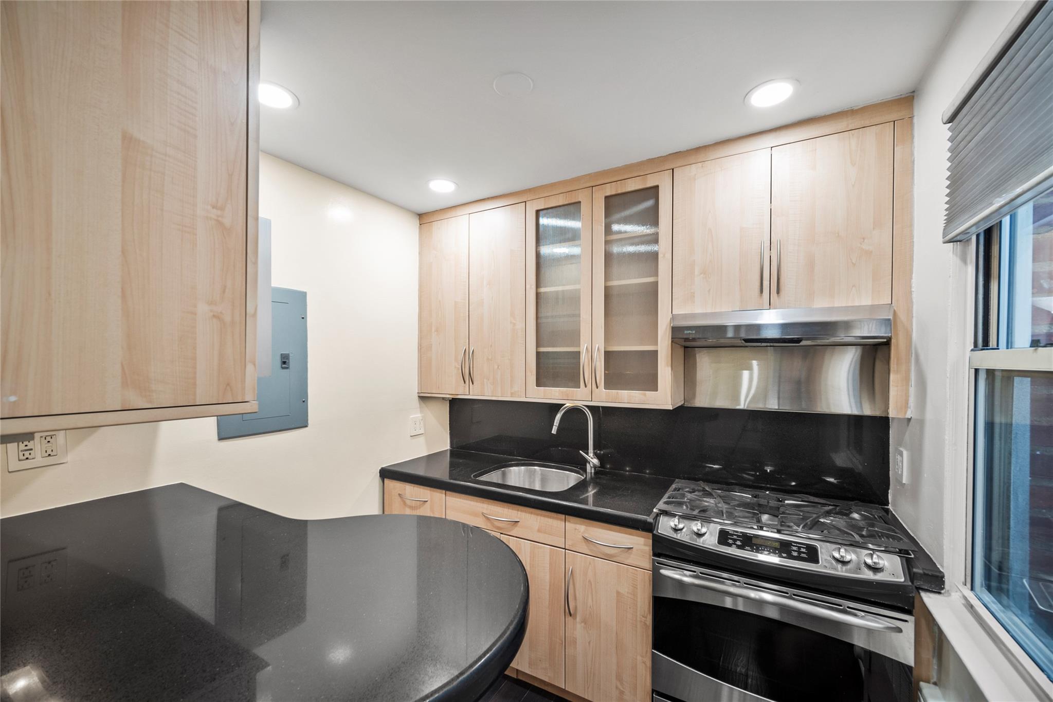 Kitchen with granite counters and stainless steel appliances.