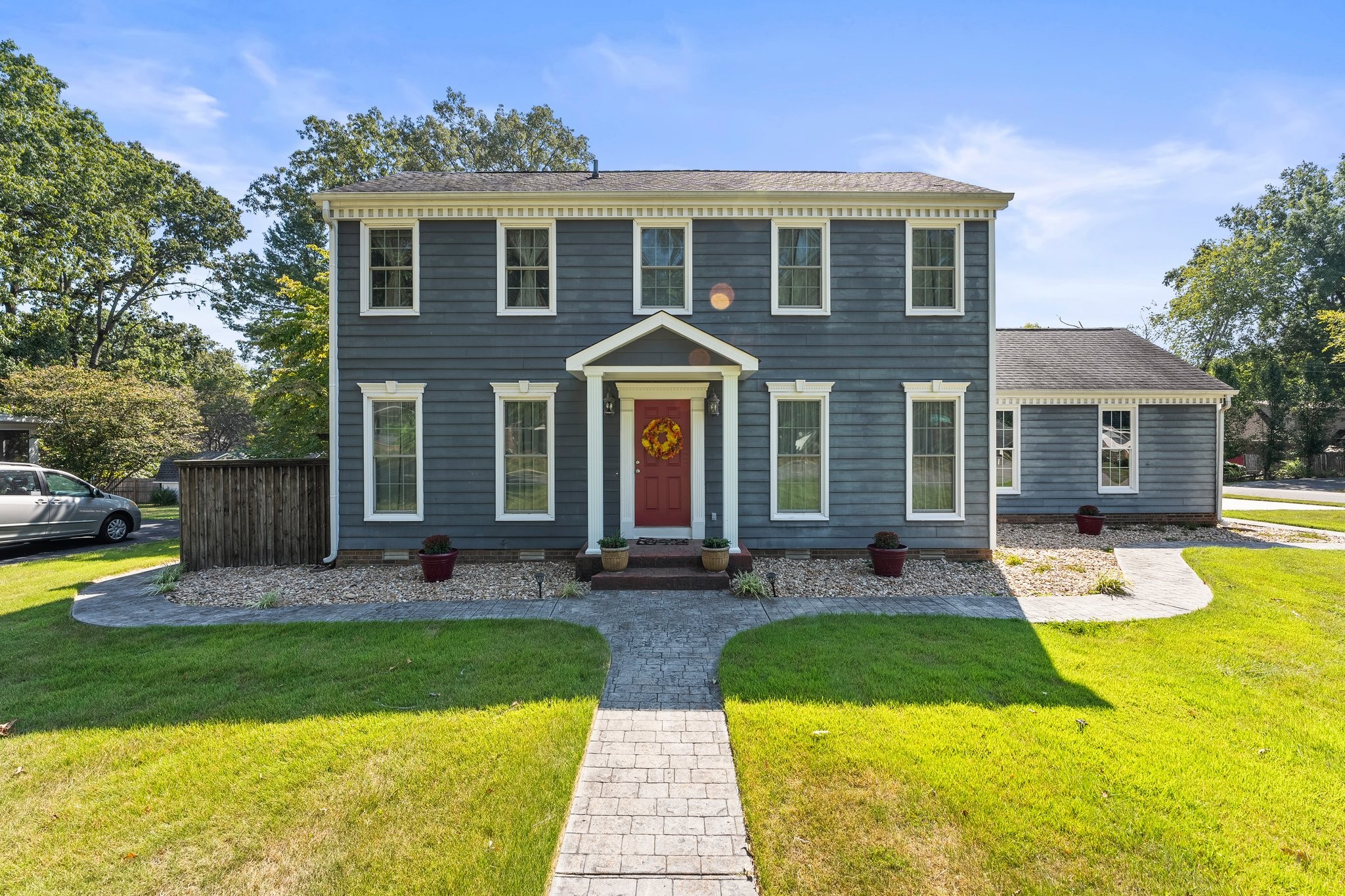 a front view of house with yard and green space