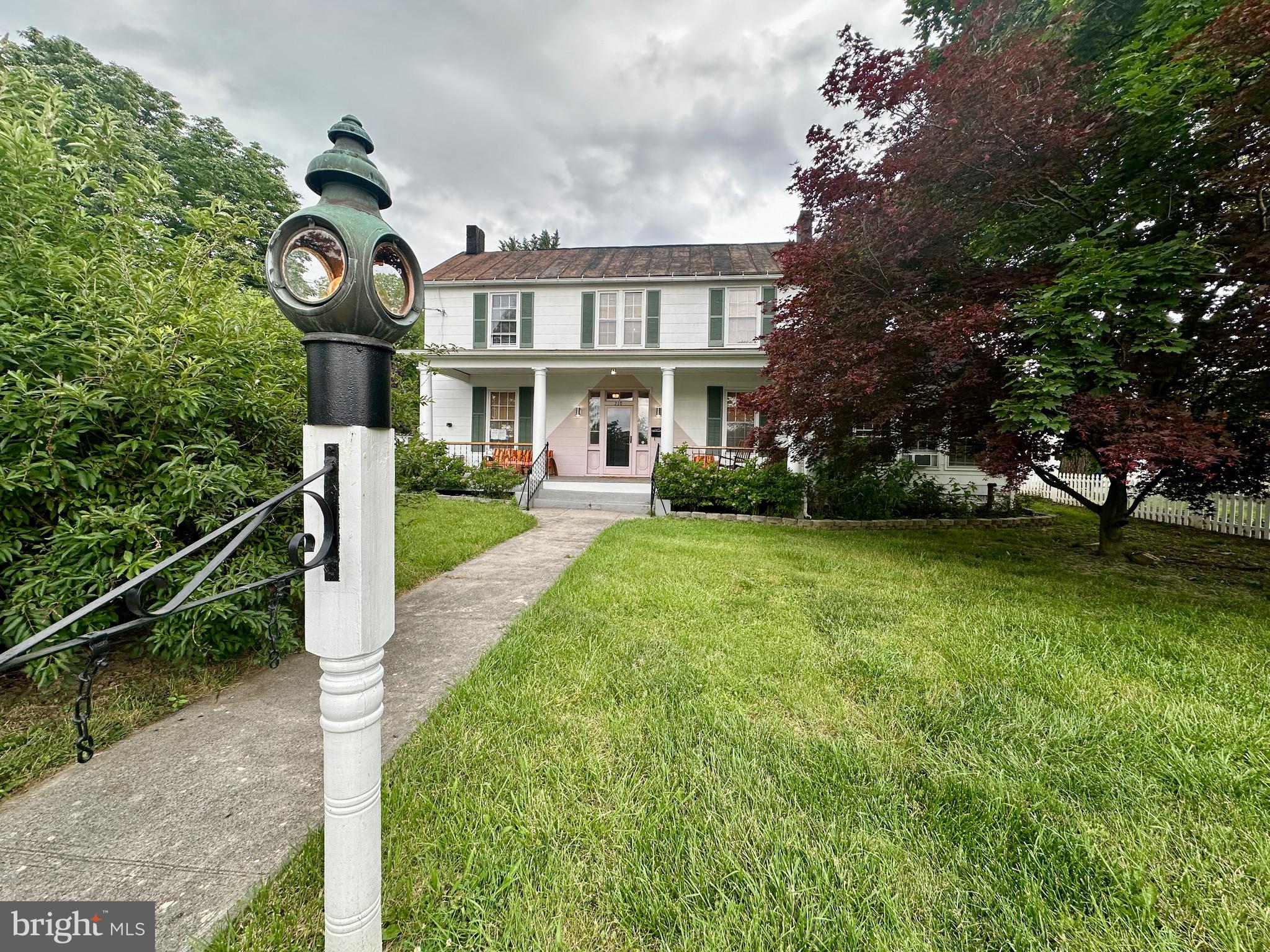 a front view of a house with garden