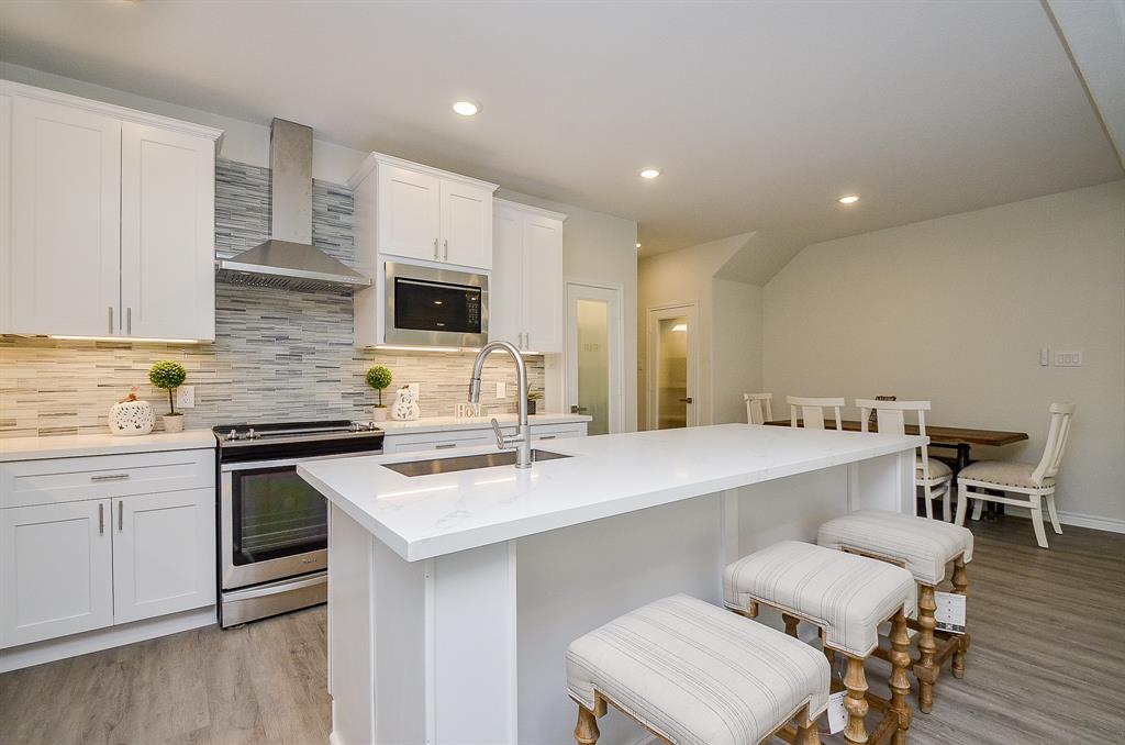 a kitchen with a sink cabinets and wooden floor