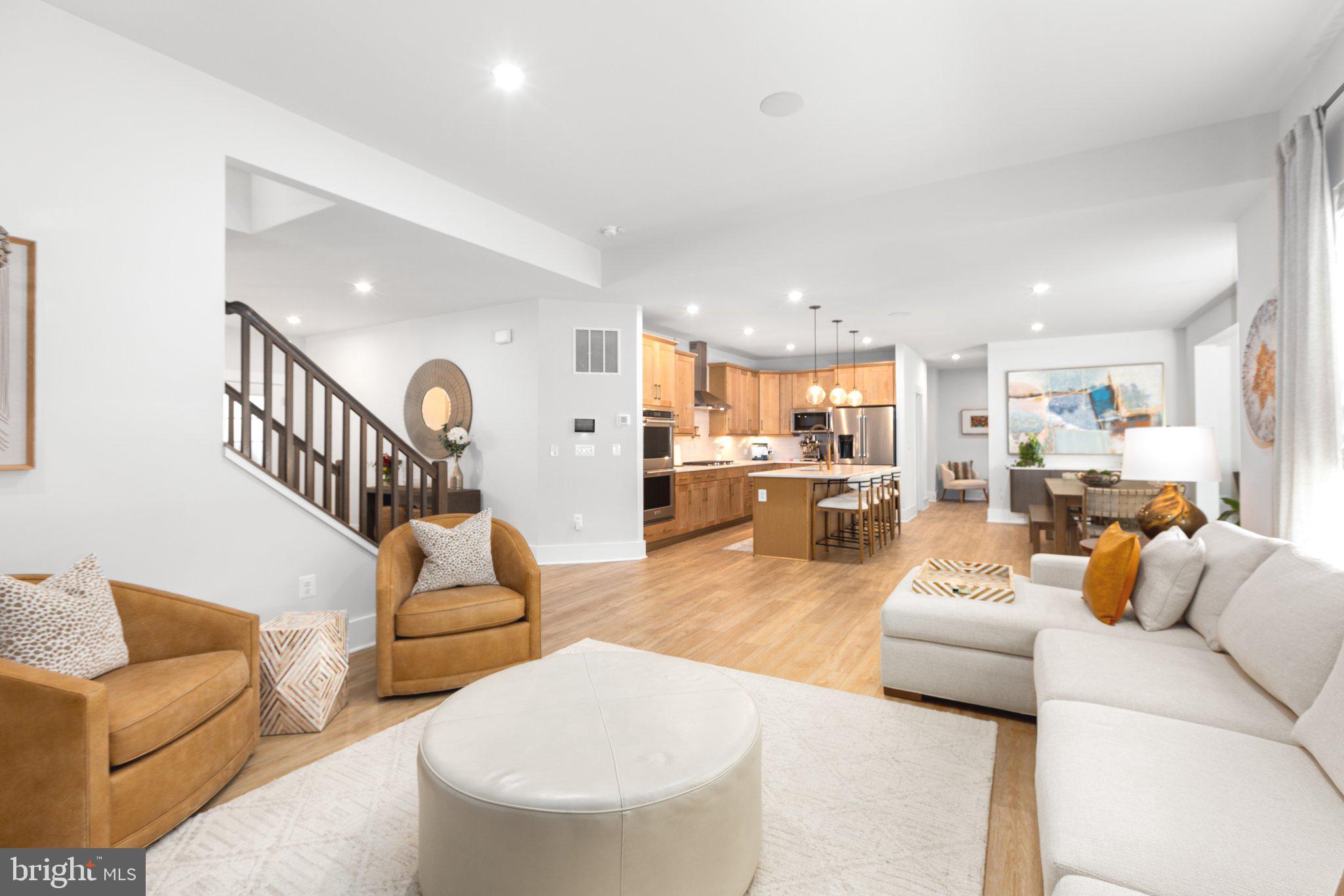 a living room with furniture and kitchen view