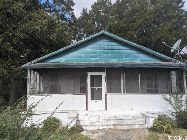 View of front of home featuring a sunroom