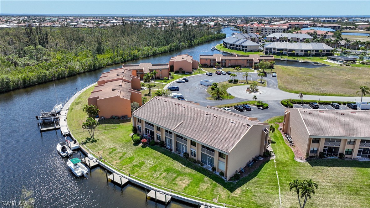 an aerial view of a house with a garden and lake view