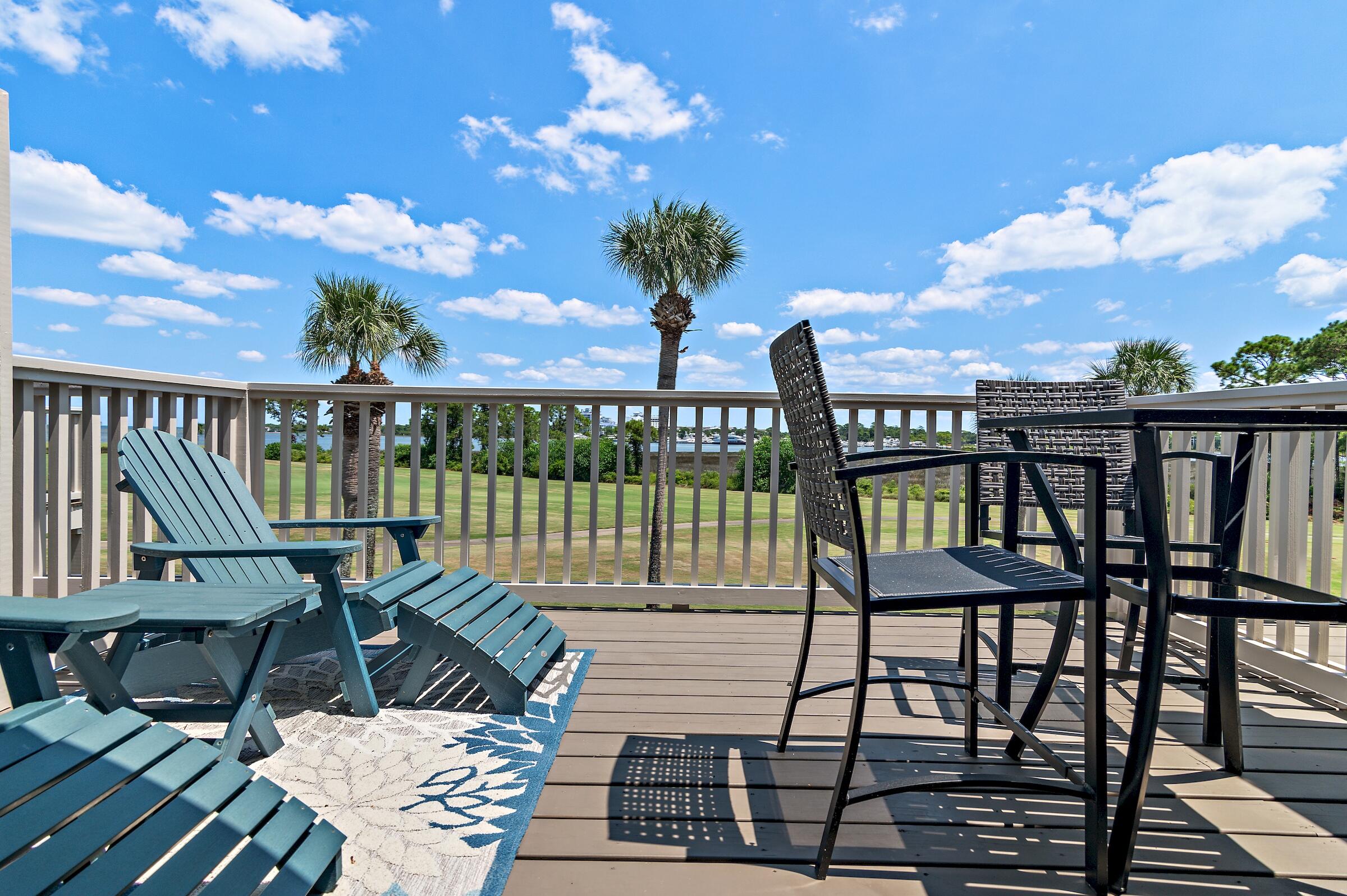 a view of a balcony with chairs and wooden floor