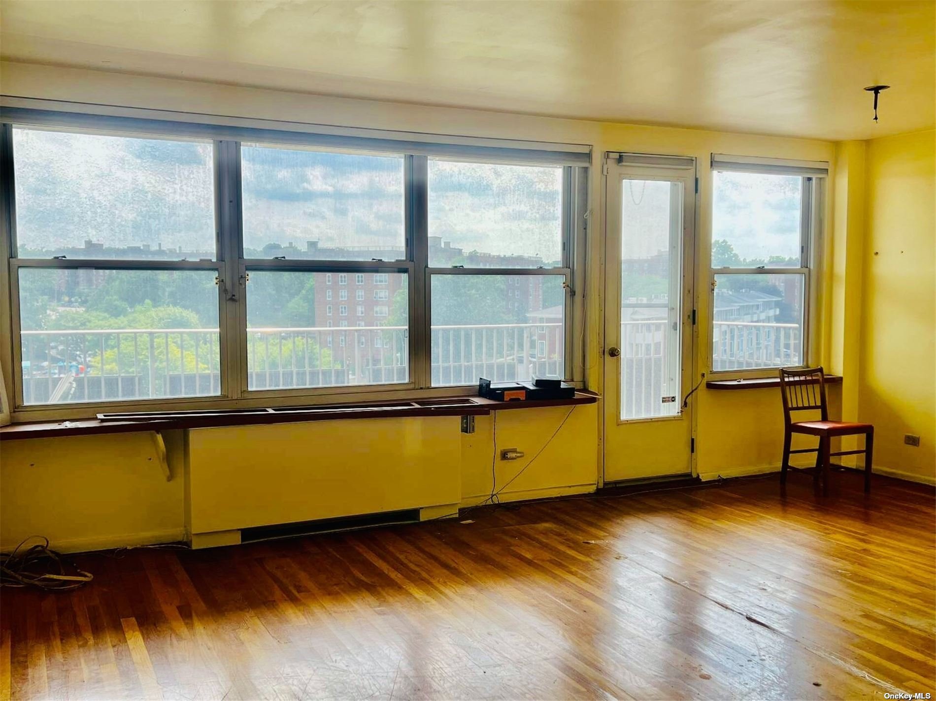 a view of a room with wooden floor and a window