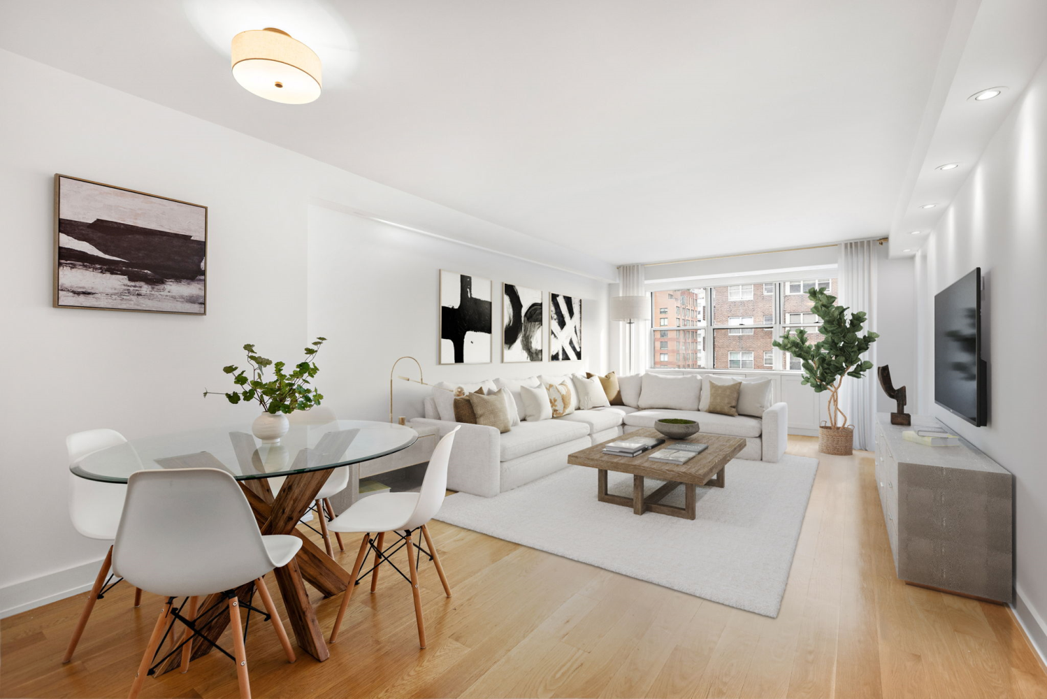 a living room with furniture potted plant and a flat screen tv