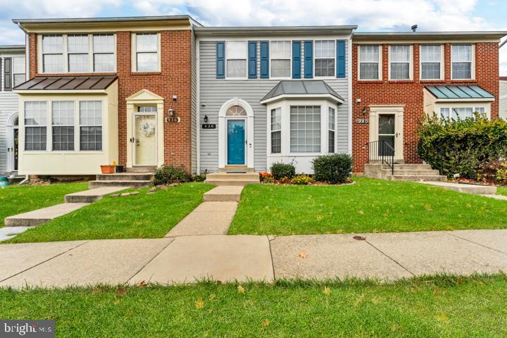 front view of a brick house with a yard