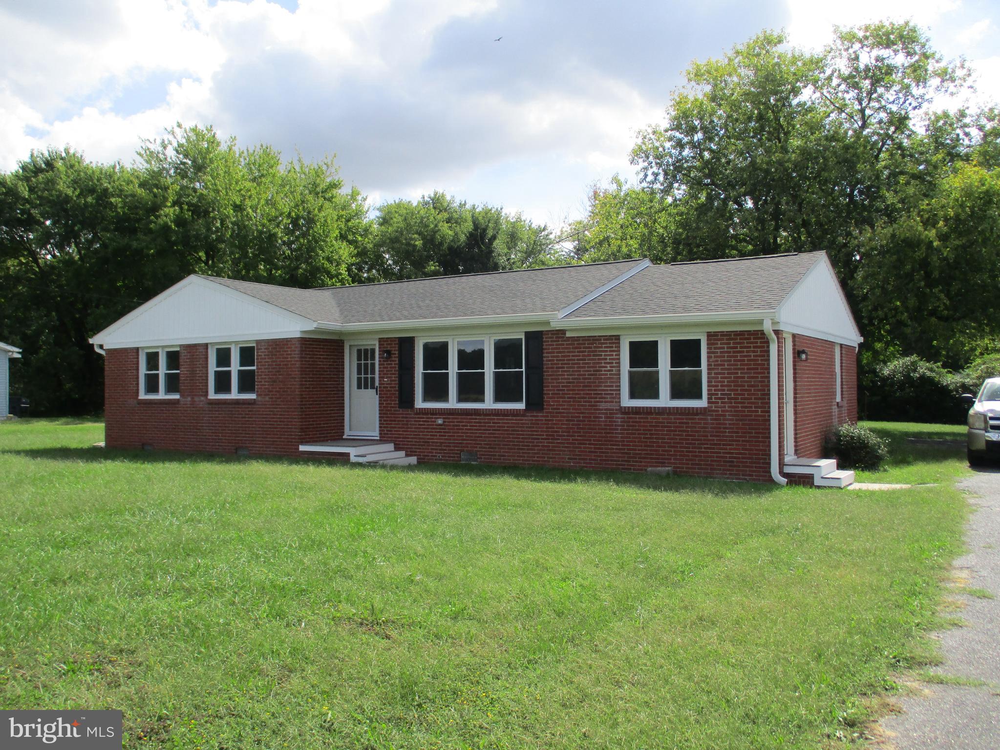 a aerial view of a house next to a yard