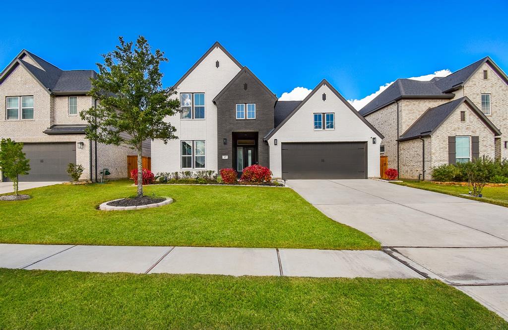 a front view of a house with a yard and garage