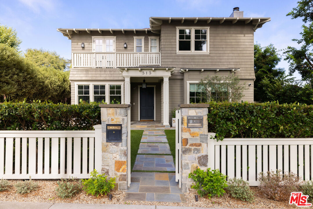 a front view of a house with a garden and plants