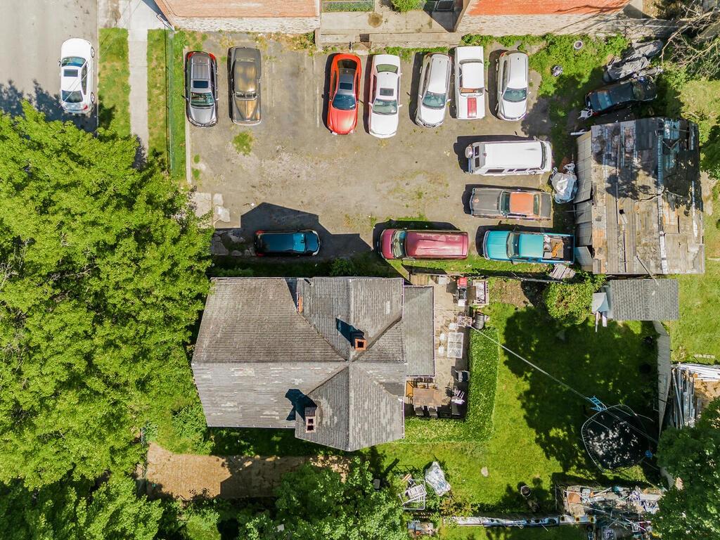 an aerial view of a house with pool and garden