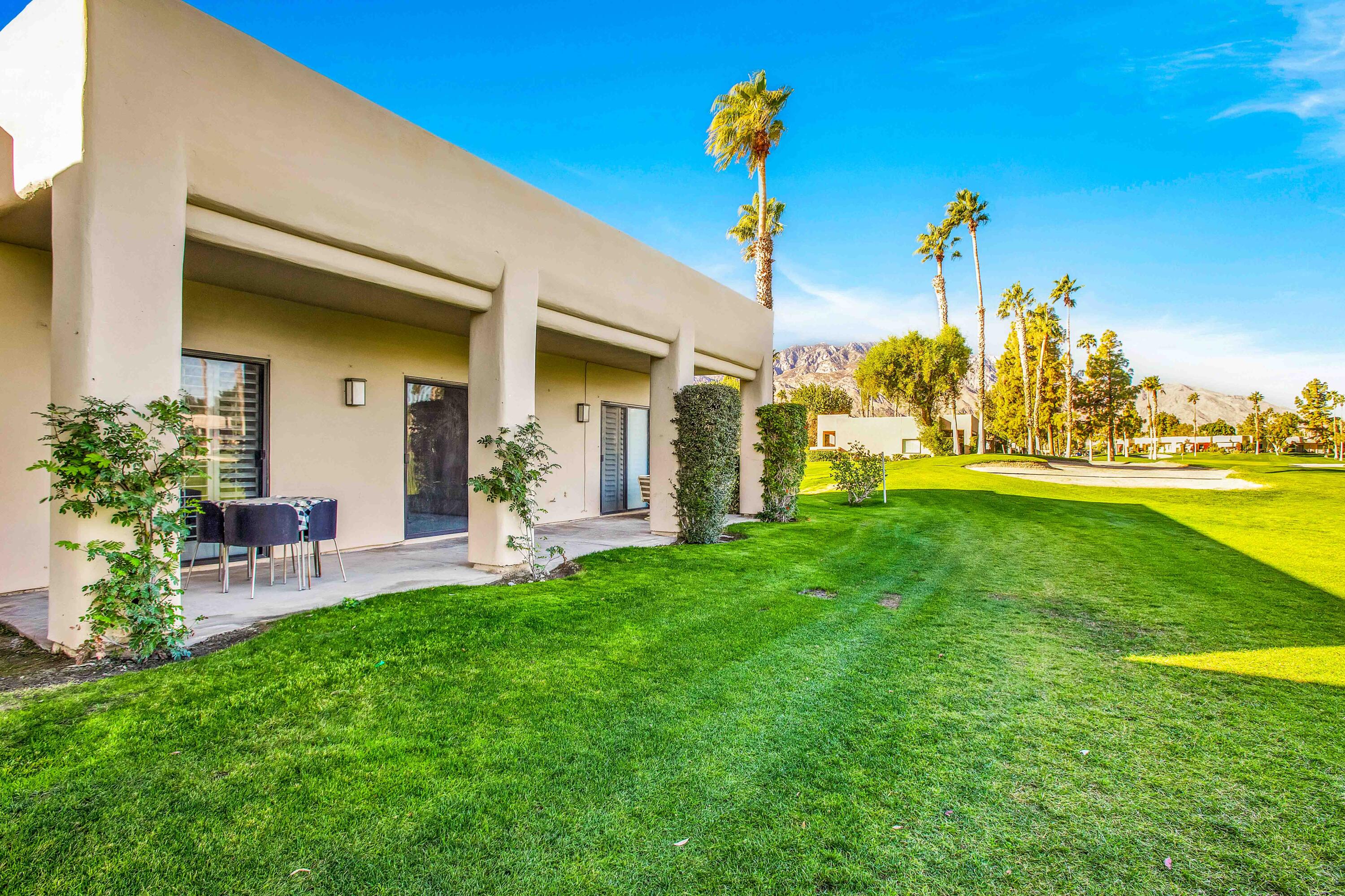 a view of a house with a backyard porch and sitting area