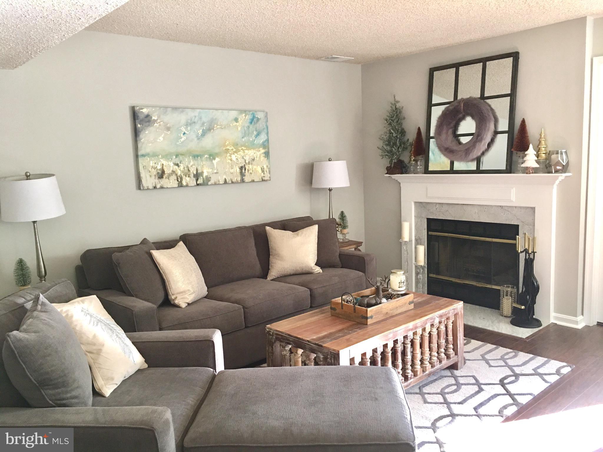 a living room with a couch and a fireplace