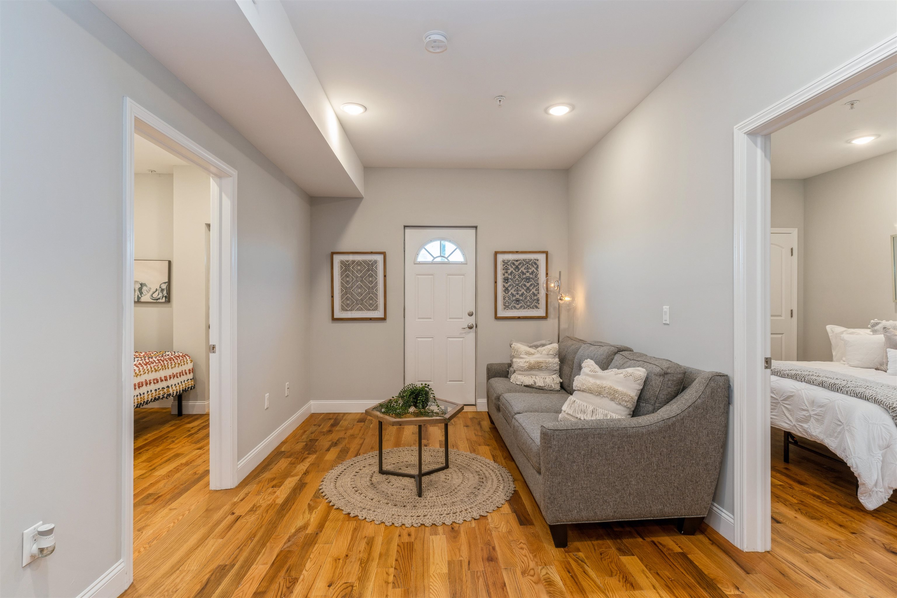 a living room with furniture and wooden floor