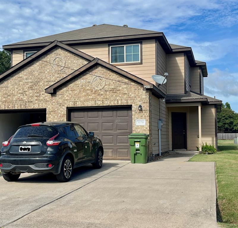 a view of a car parked front of a house