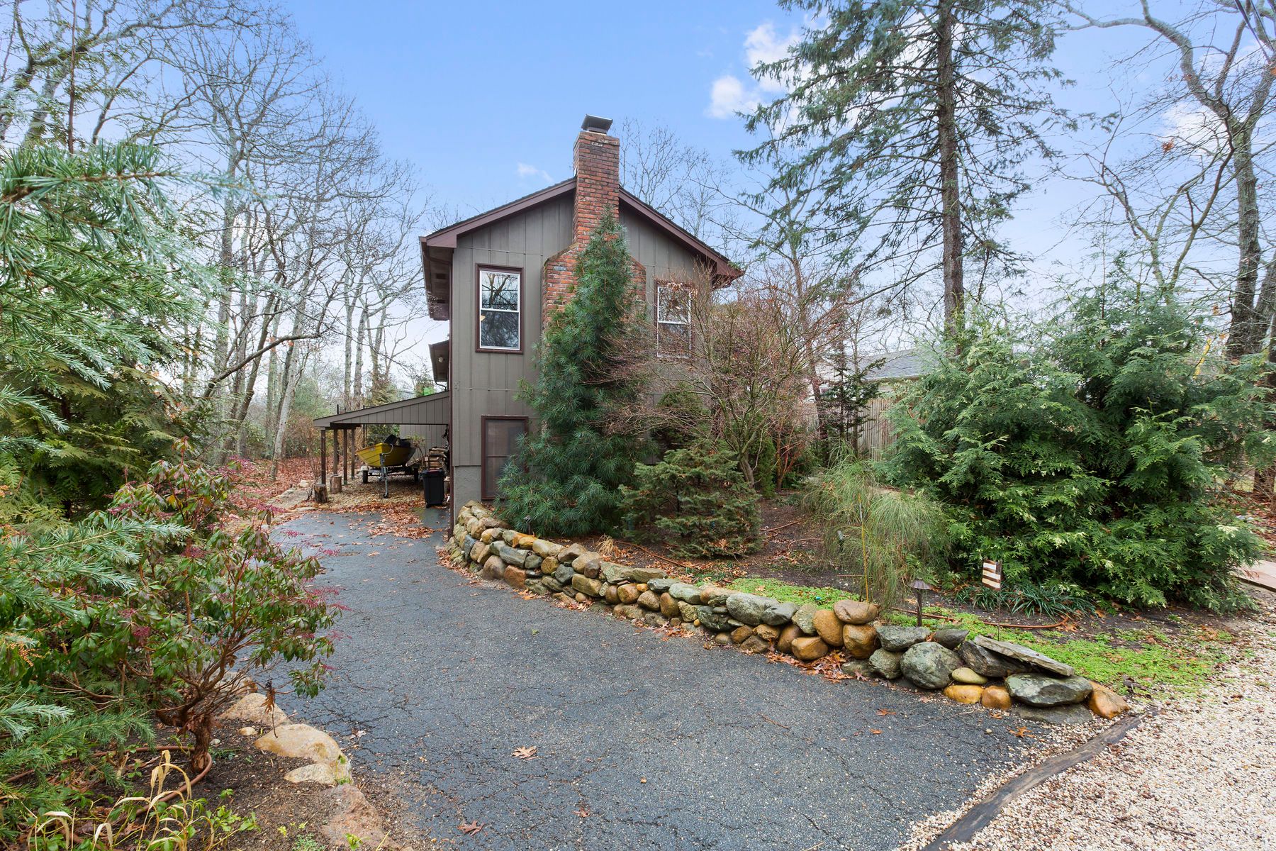 a view of a house with a yard siting area and garden