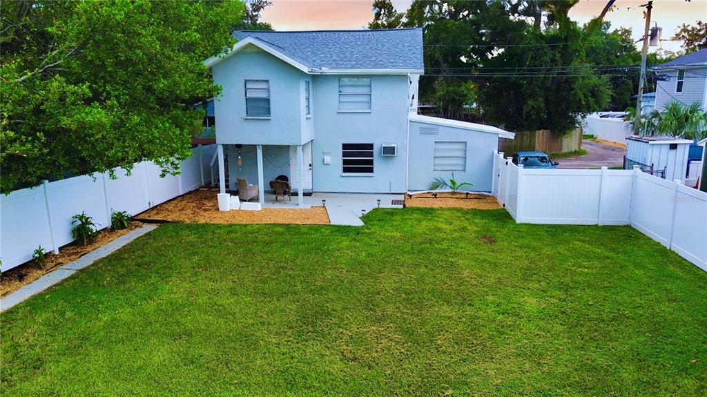 a view of a house with a yard and sitting area