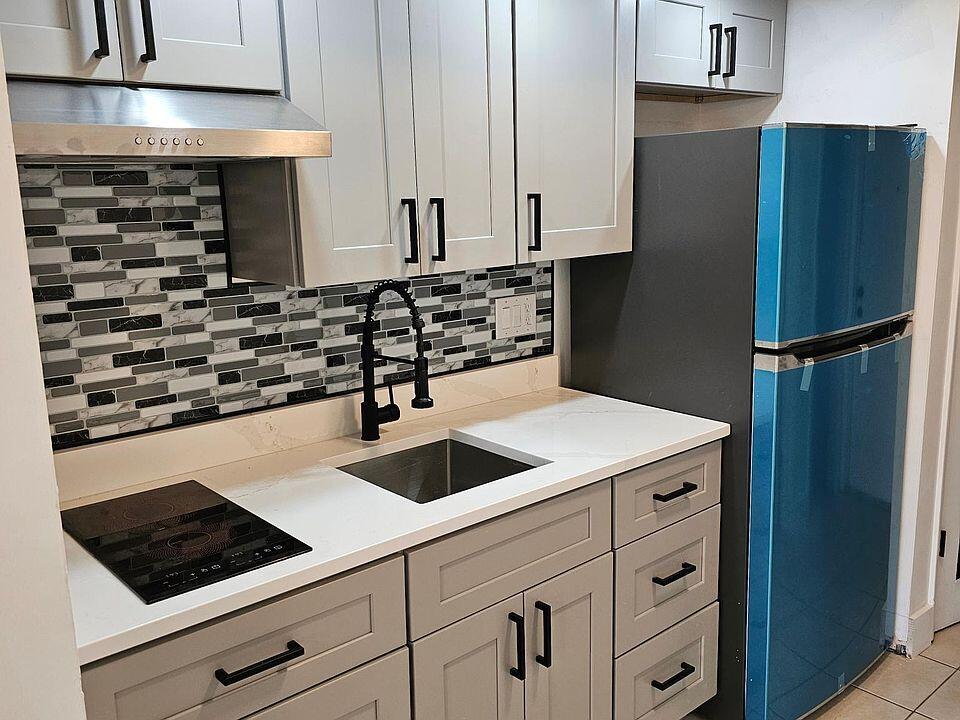 a kitchen with appliances and cabinets