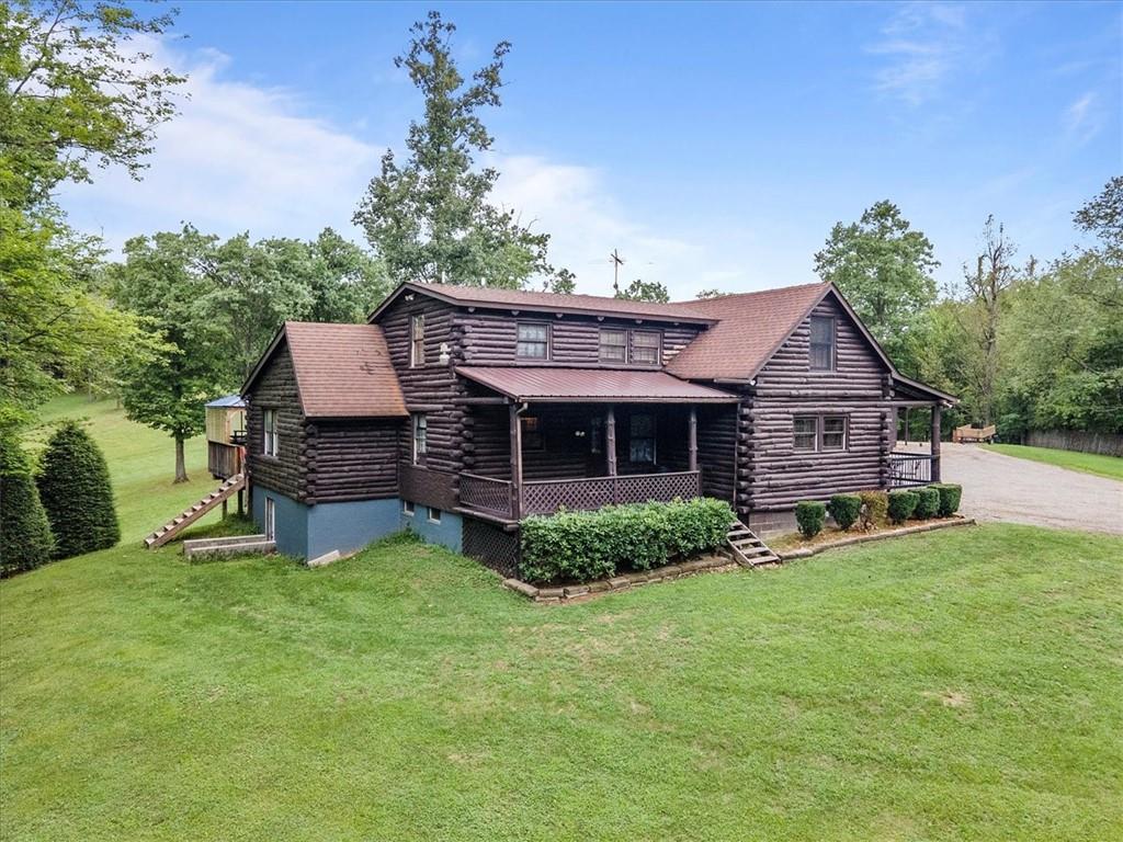 a view of a house with a yard porch and sitting area