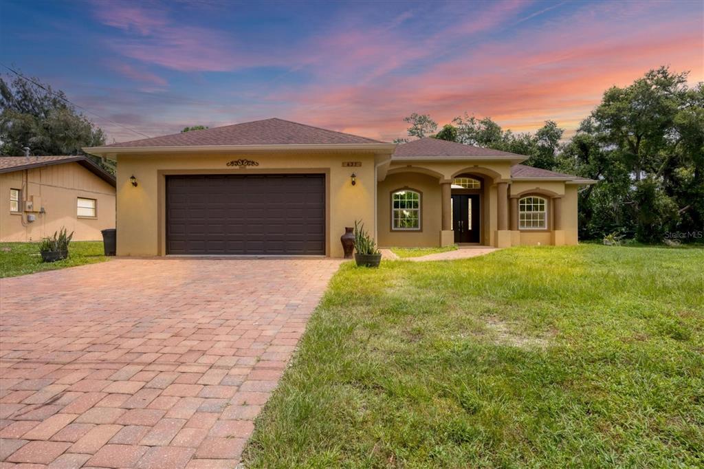 a front view of a house with a yard and garage