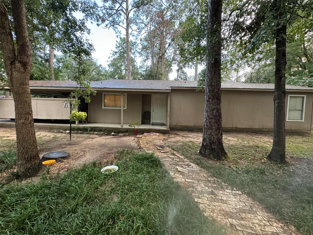 a backyard of a house with yard and tree