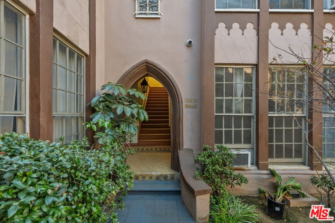 a front view of a house with plants