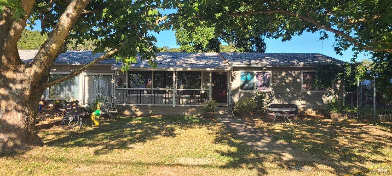 a view of house with a tree in front of it