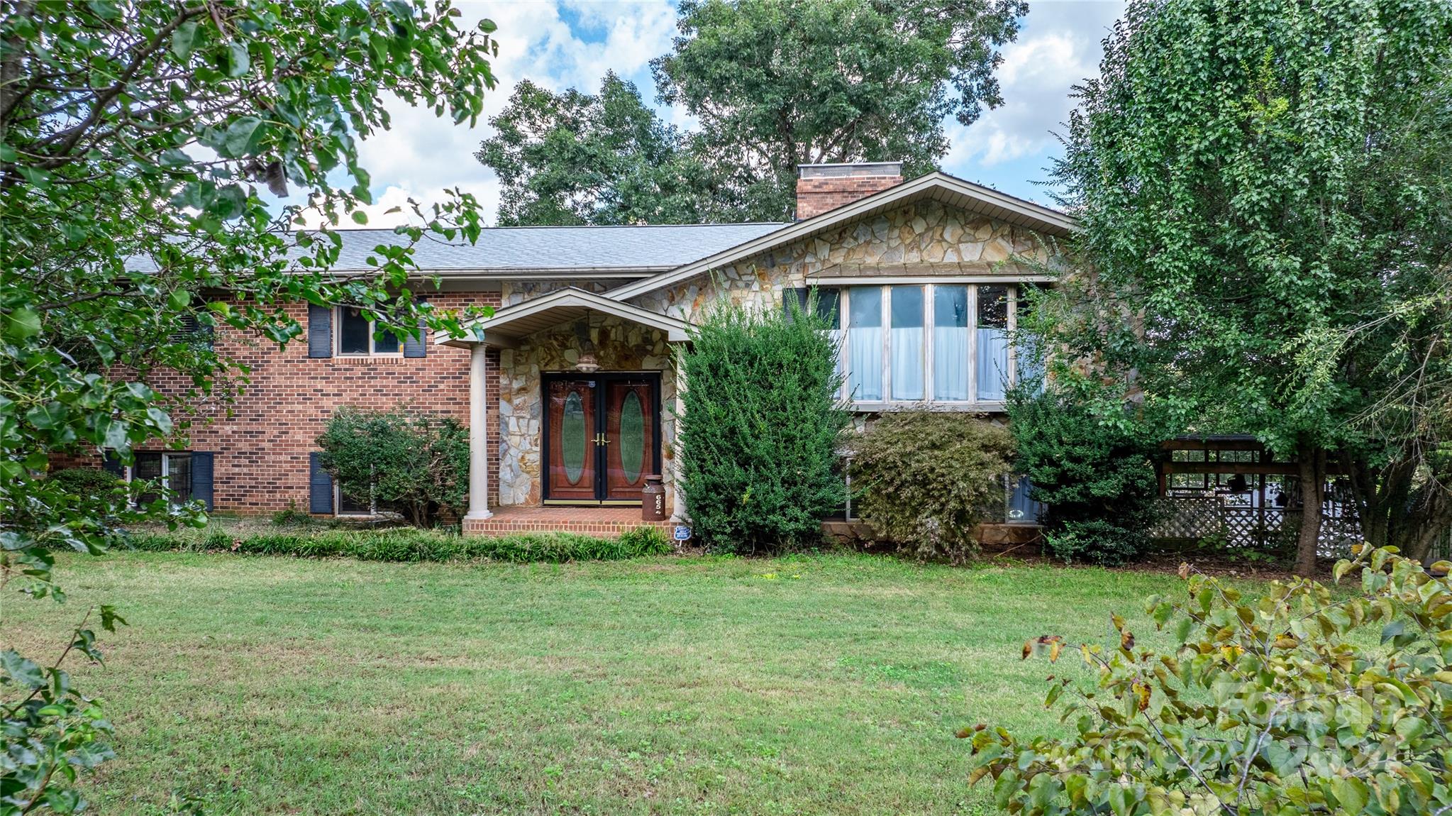 a front view of a house with garden