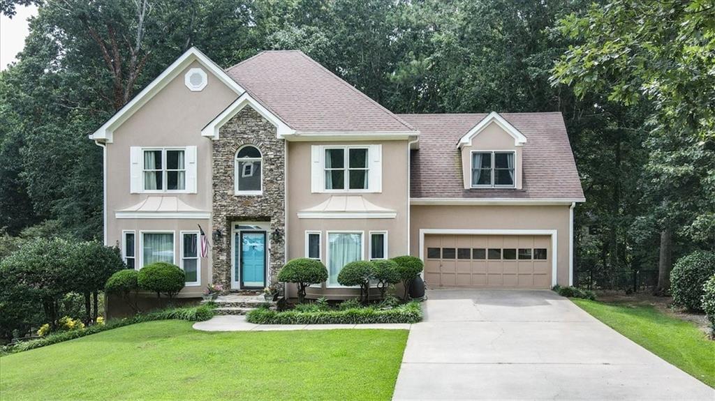 a front view of a house with a yard