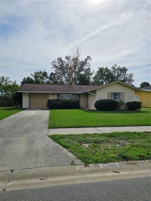 a front view of a house with a yard and a garage