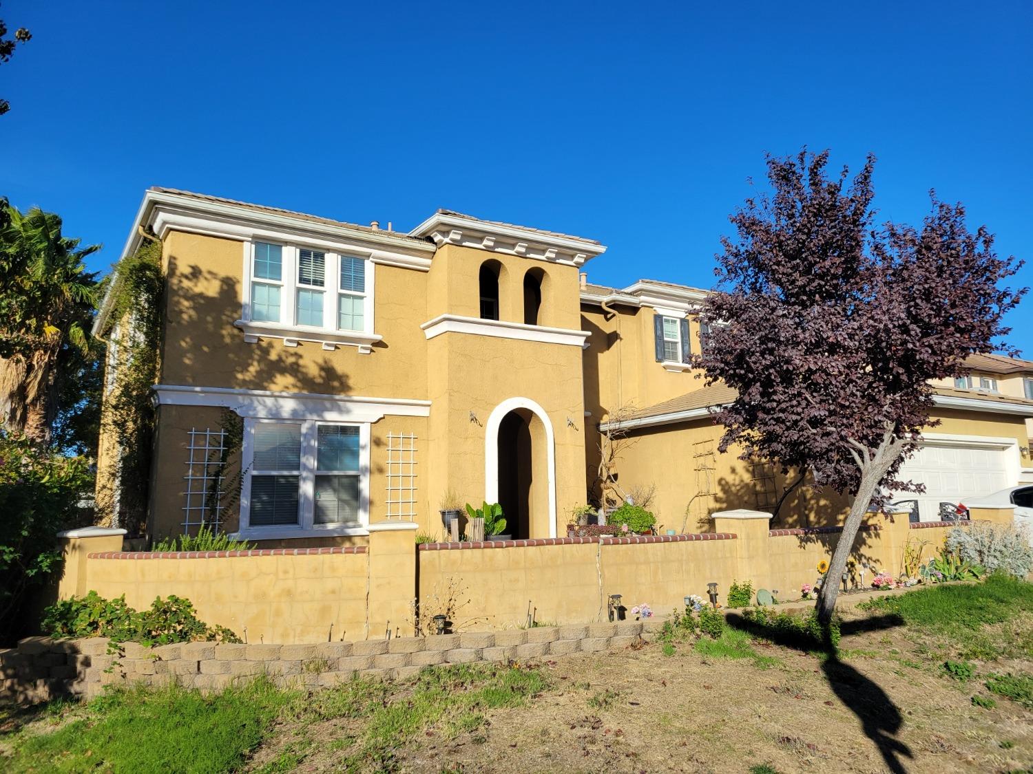 a front view of a house with a yard