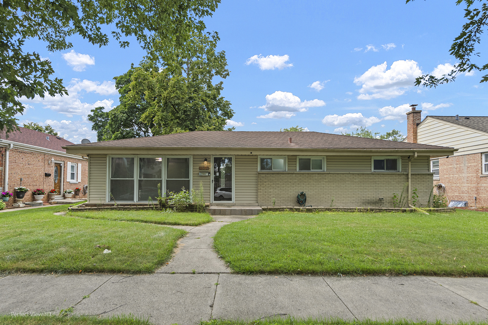 a front view of a house with a garden and plants