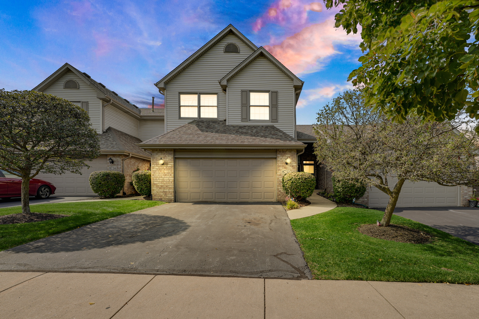 a front view of a house with a yard and garage