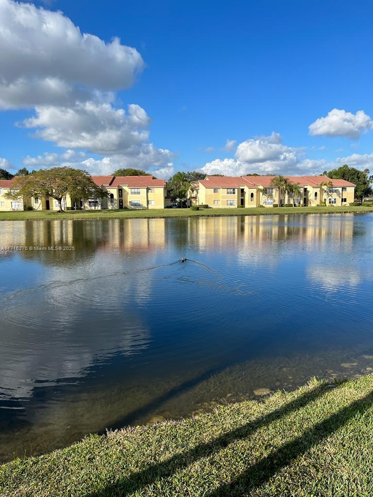 a view of a lake with houses in the back