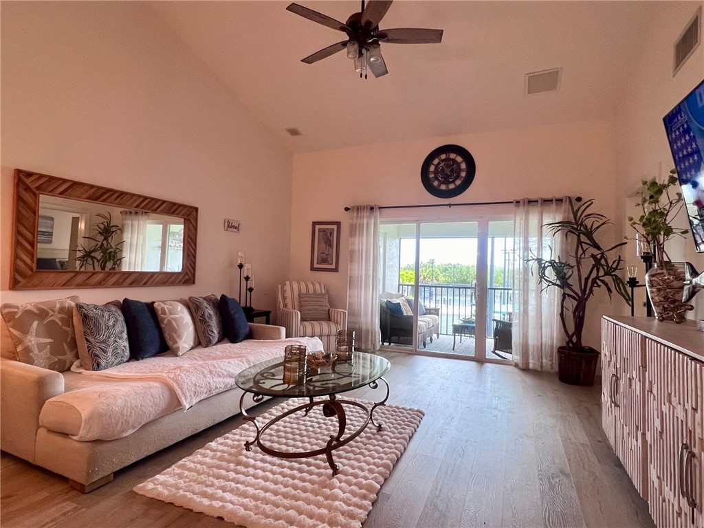 a living room with furniture a rug and a large window