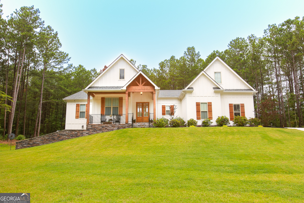 a front view of a house with a garden