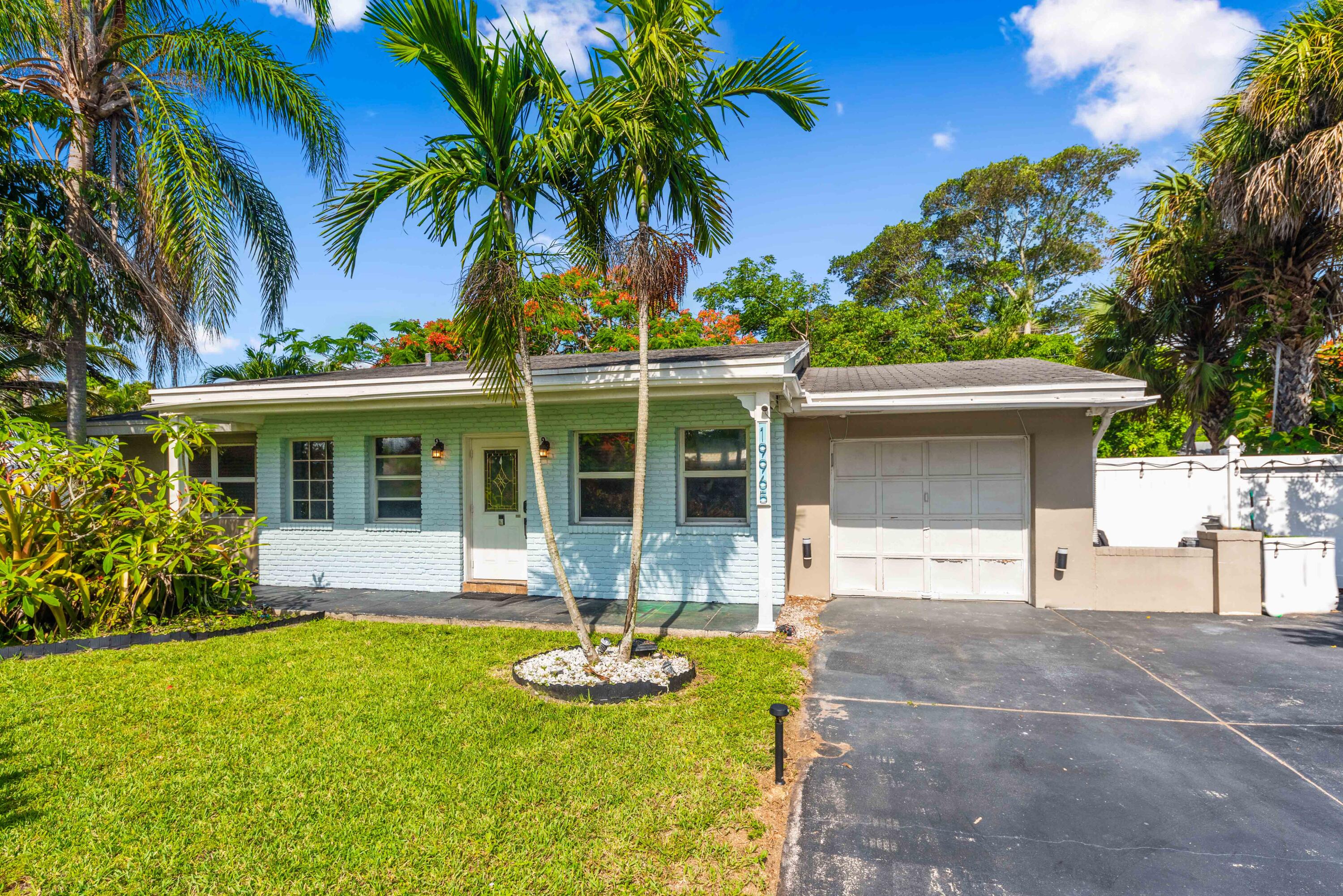 a front view of house with yard and swimming pool