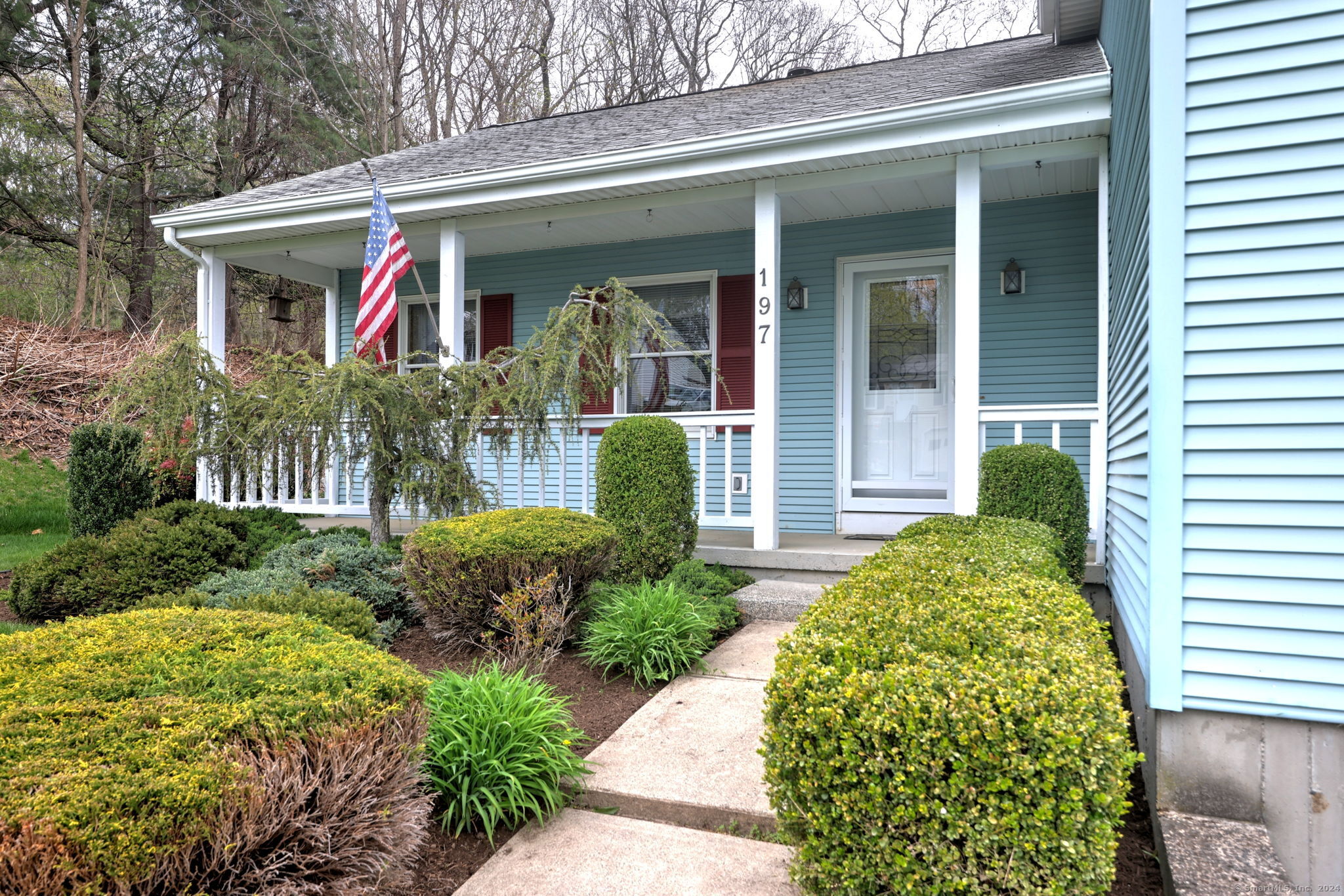 a front view of a house with garden