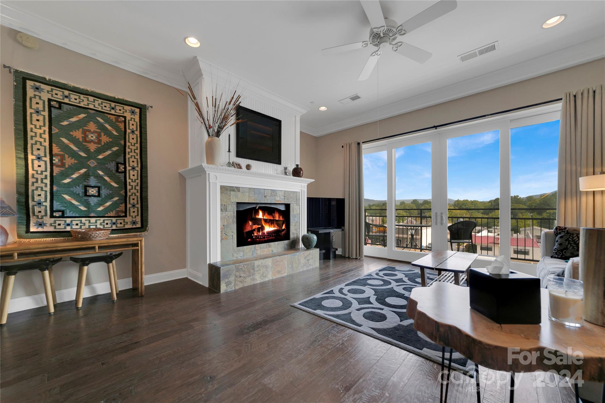 a living room with furniture a fireplace and a flat screen tv