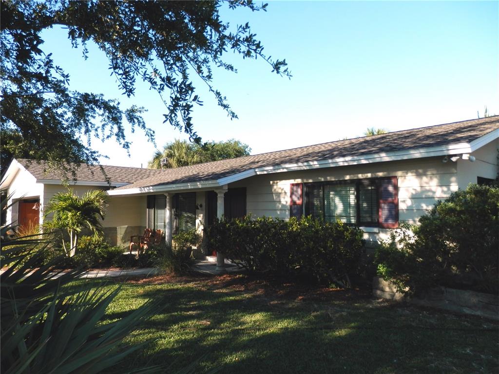 a view of a house with yard porch and furniture